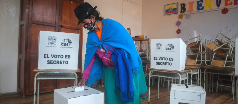 A woman from the Indigenous community casts her vote during the 2021 Ecuador general elections. © Sipa USA via AP
